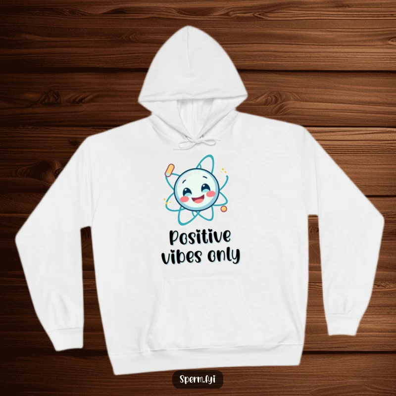Funny, cozy hoodie featuring a smiling atom character spinning energetically, offering warmth and a humorous scientific theme.